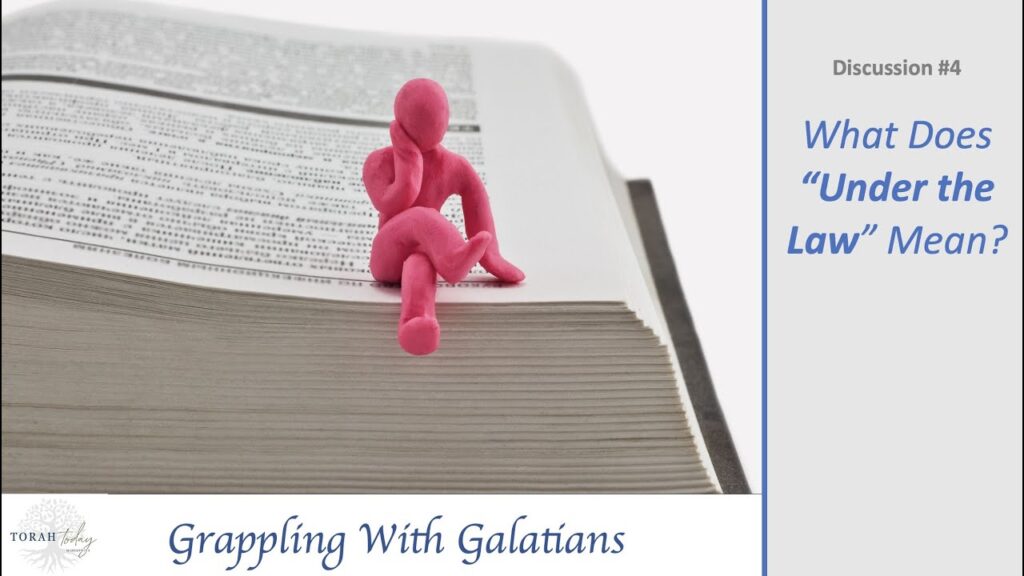 Grappling with Galatians. Discussion #4 Title - what does under the law mean. image of a pink clay man witting in a thinking position legs crossed on the edge of an open book